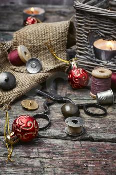 Set of sewing tools on a wooden table and Christmas tree decorations