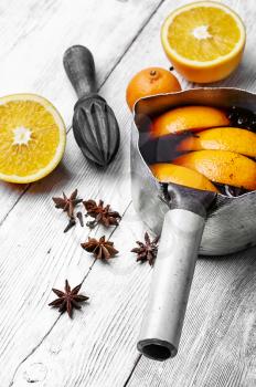 hot drink based on red wine,orange and spices in saucepan