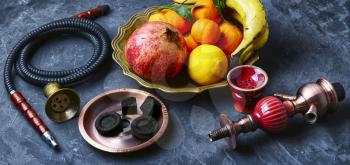 banner with smoking hookah and dish with tangerines,pomegranate and banana
