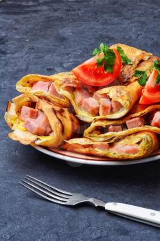 Tasty pancakes stuffed with meat and mushrooms on the plate