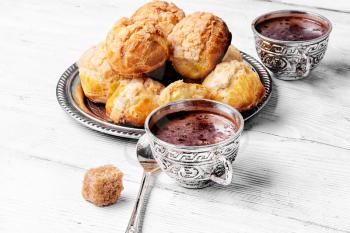 Homemade profiteroles dessert and cup hot chocolate