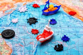 Symbolic toy ship on a topographic map of the world