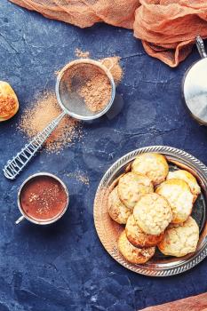 Homemade profiteroles dessert and cup hot cocoa
