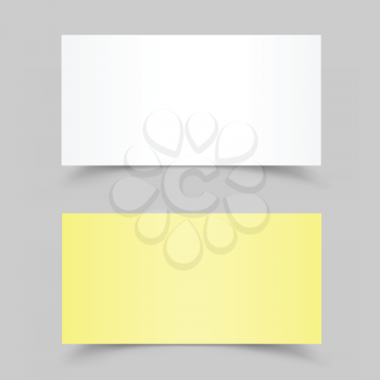 The white and yellow pieces of paper on the gray background
