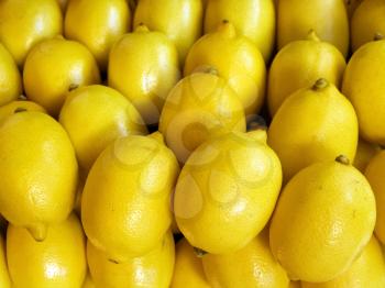 A pile of beautiful lemons on a counter