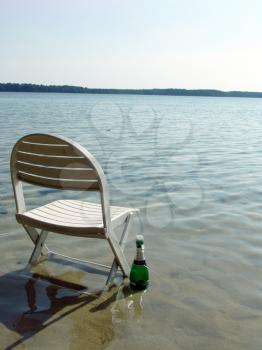 The chair and champagne on the lake beach
