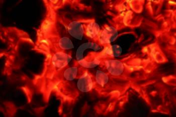 Ash fire blurred in dark night. Campfire blurry coals burn in the darkness. Ejection nofocus lava