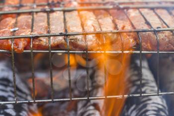 Raw meat steak fry on the grill fire. Barbecue fresh food delicious pork cooking on metal grid