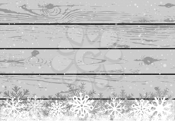 Christmas snow on gray wooden plank background. Winter snowflake wood backdrop