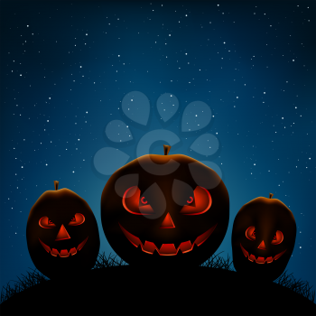 Halloween Holiday pumpkins on dark night background. Scary smiling pumpkin faces in darkness and starlight backdrop