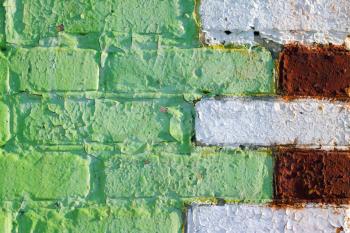 Old paint on brick wall. Green white red brickwork backdrop. Decorative brick wall background. Retro grunge construction building design