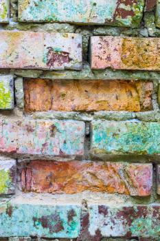 Old grunge colored brick wall background. Vertical brickwork decor backdrop. Architecture texture design