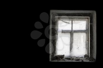 Old window in dark and cobweb around. Scary darkness abandoned non-residential room