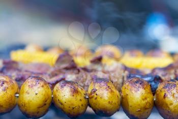 Barbecue grill cooking. Tasty kebab potatoes dinner cook. Food BBQ background. Roasted fresh beef meat