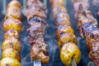 Barbecue kebab cooking. Grill potatoes dinner cook. Tasty food BBQ background. Roasted fresh beef meat