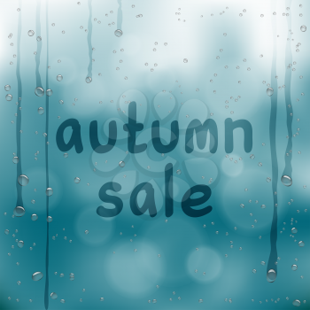 Autumn sale written on wet glass. Rainy window and hand written text on dark blue sky background