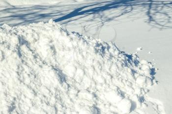 Winter snow cover and tree shadow. Fresh snowdrift backdrop. Snowy hill covered landscape. Snowflake and ice in sunlight
