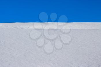 Snow cover and winter sky. Fresh snowdrift backdrop. Snowy covered landscape. Snowflake and ice in sunlight