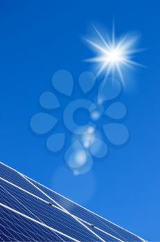 Sun and solar panels on blue sky background. Sunlight clean energy power. Renewable green cheap electricity