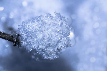 Glistening ice crystals lie on the background of the snow surface