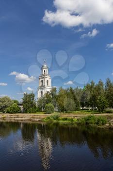 Bell tower stands near the river, outdoors shot, day light, Russia