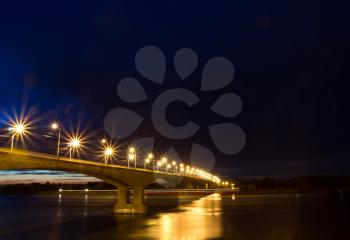 Night bridge over the Volga River, dotted with dozens of lanterns. Russia, Yaroslavl