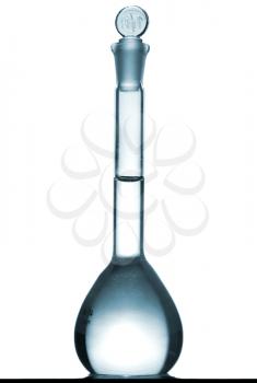 Isolated chemical volumetric flask on table with a small reflection, studio shot