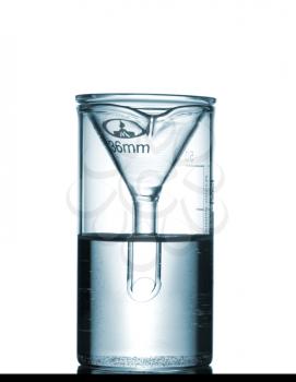 Isolated chemical beaker with funnel and solution on table with a small reflection, studio shot, isolated on white