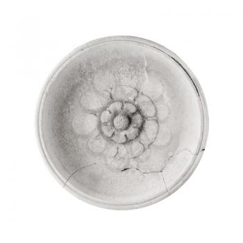 Ancient round decoration element with sculpted flower pattern isolated on white