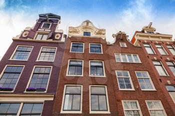 Living houses facades with blue sky. Amsterdam, Netherlands