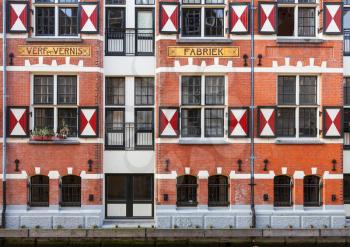 Exterior of quaint houses along a canal in Amsterdam, Netherlands