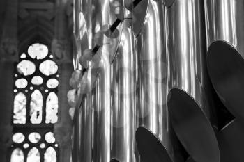 Closeup black and white photo of organ in Catholic Church