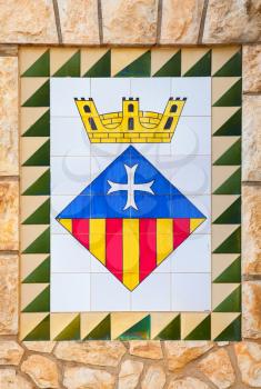 Calafell, Spain - August 13, 2014: Calafell town Coat of arms on the old stone wall,  Catalonia, Tarragona region, Spain
