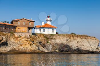 Lighthouse and wooden buildings on St. Anastasia Island. Black Sea, Bulgaria