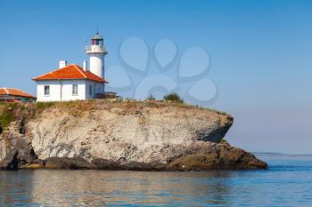 White lighthouse with red light on St. Anastasia Island. Black Sea, Bulgaria