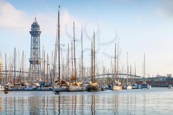Port of Barcelona, Spain. Yachts, sailing boats and old big tower