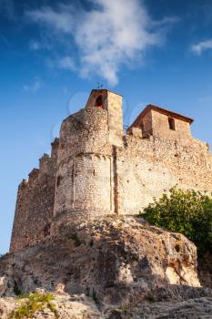 Medieval stone castle on the rock in Spain. Main landmark of Calafell town, vertical photo