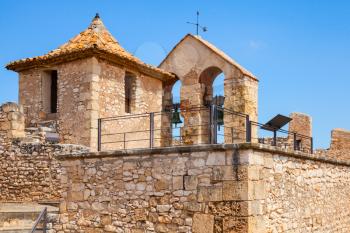 Medieval castle in Calafell town, Spain. Stone tower and bells in arches