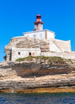 Madonetta lighthouse. Entrance to Bonifacio port, Corsica island, France, vertical photo
