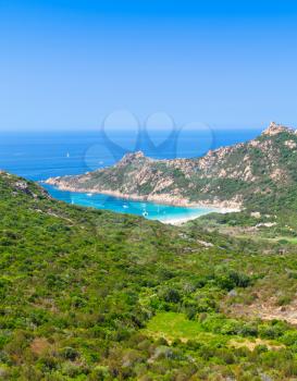 Corsica island, vertical coastal landscape with mountains and beach. Mediterranean Sea coast, France