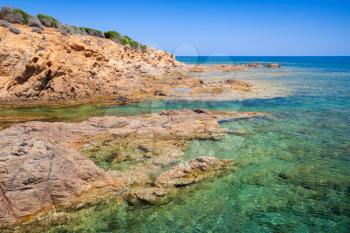 Coastal landscape with rocky wild beach and blue lagoon, Corsica island, France. Plage De Capo Di Feno