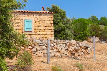 Typically rural landscape of Corsica, France. Old stone house and trees