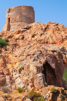 Ancient Genoese tower on Capo Rosso, Corsica island, France. Vertical photo