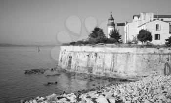 Ajaccio, citadel with white lighthouse tower, Corsica island, France. Monochrome photo