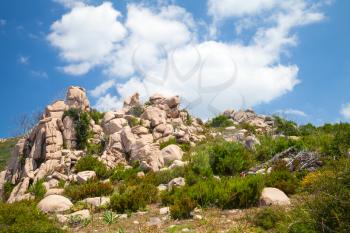 Natural landscape of Corsica island, rocky mountains under dramatic cloudy sky