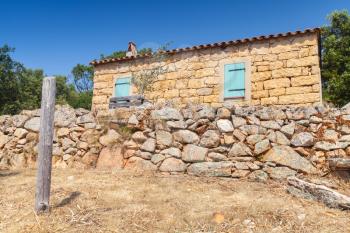 South Corsica, rural landscape with old typically small house made of yellow stones