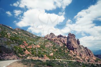 Landscape background of Corsica with turning mountain road and mountains, tonal correction photo filter effect