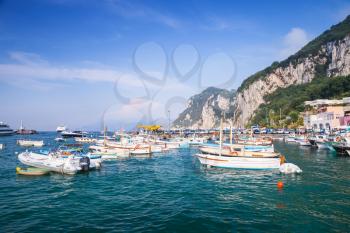 Port of Capri island, Italy. Colorful houses and moored boats