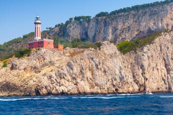 Punta Carena Lighthouse stands on the rocky coast of Capri island, Italy