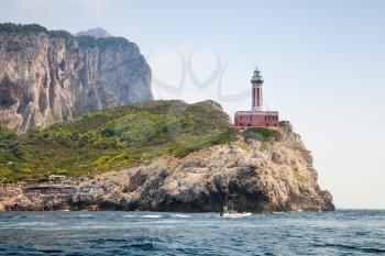Punta Carena Lighthouse tower stands on the rocky coast of Capri island, Italy